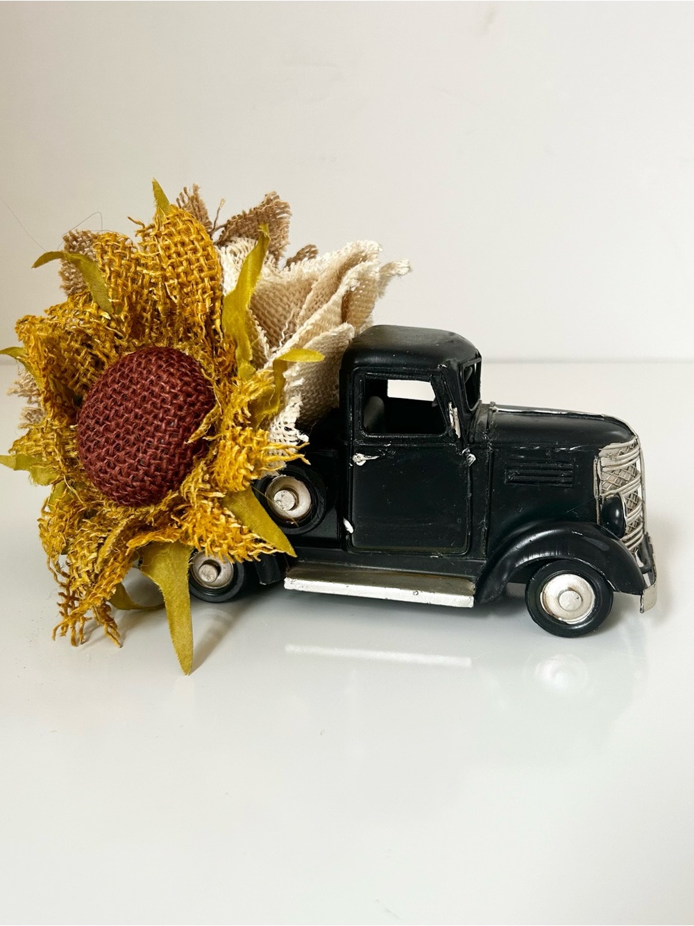 Vintage-Style Black Farm Truck with Yellow Sunflower Arrangement